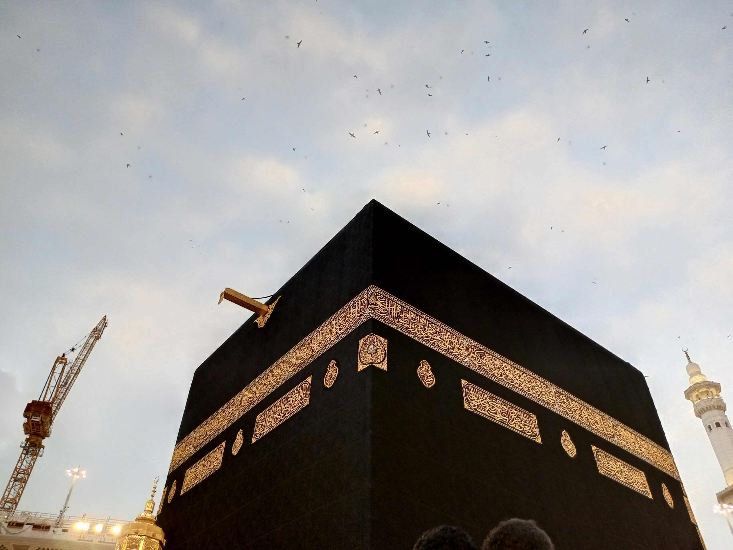 View of the Kaaba at dusk with a clear sky in Mecca, Saudi Arabia.